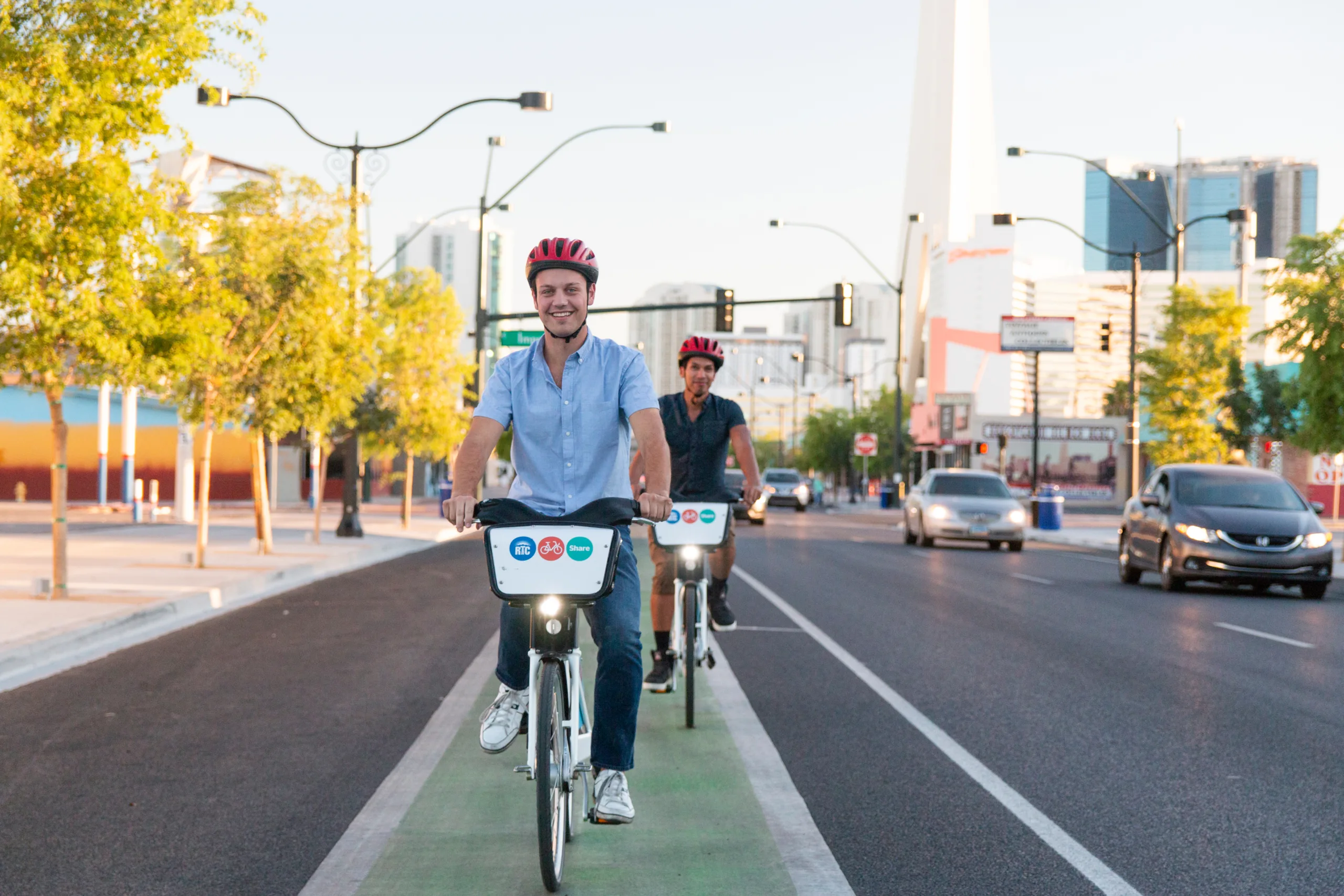 A group of people riding bicycles on a street.