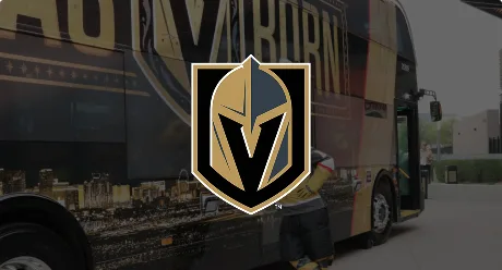 A logo of the Vegas Golden Knights hockey team is centered over a background showing a branded tour bus with gold and black colors and cityscape graphics.