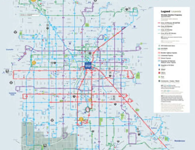 A detailed city transit map showing various bus and light rail routes in different colors, with a legend explaining route types and key locations marked across the urban area.